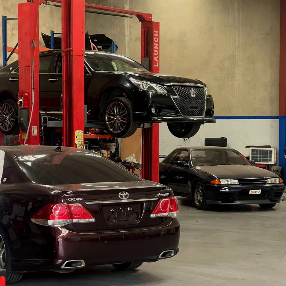 Cars on the hoist inside the Profect Automotive workshop