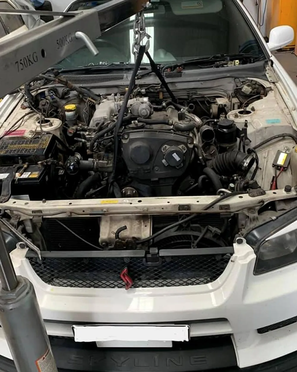 An engine lifted out during a rebuild at Profect Automotive